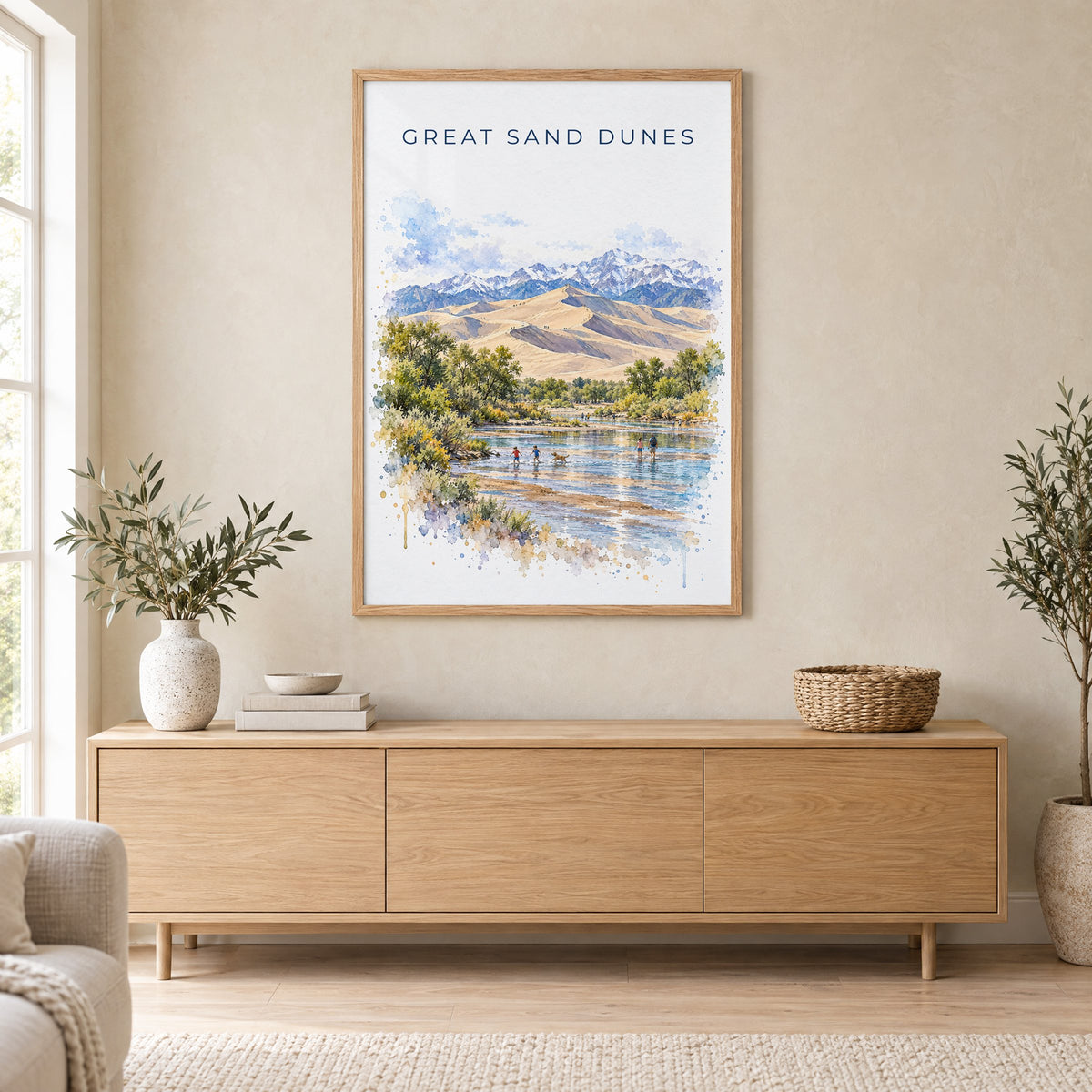 Great Sand Dunes National Park watercolor print in an oak frame above a light wood sideboard in a Scandinavian living room