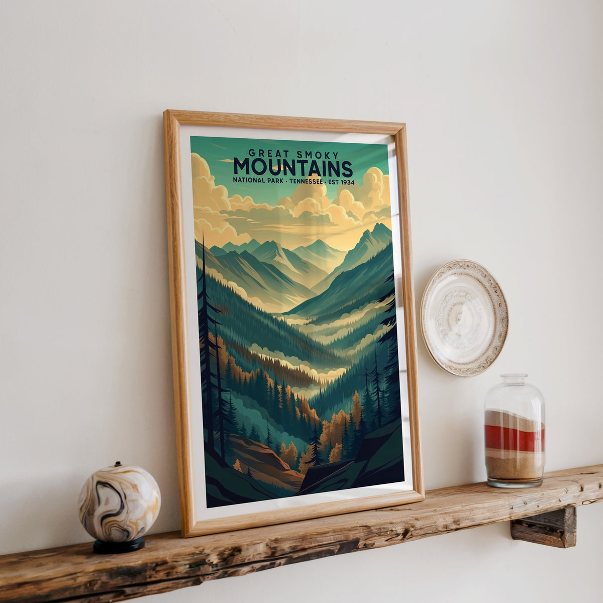 Great Smoky Mountains print in an oak frame on a rustic wood shelf with ceramics and a sand jar
