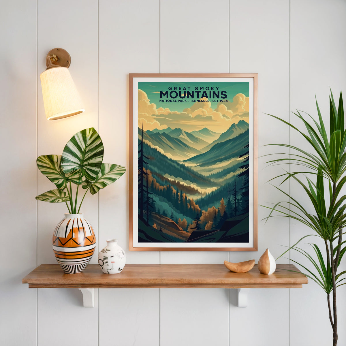 Great Smoky Mountains print in a copper frame above an oak shelf on white shiplap with a brass sconce