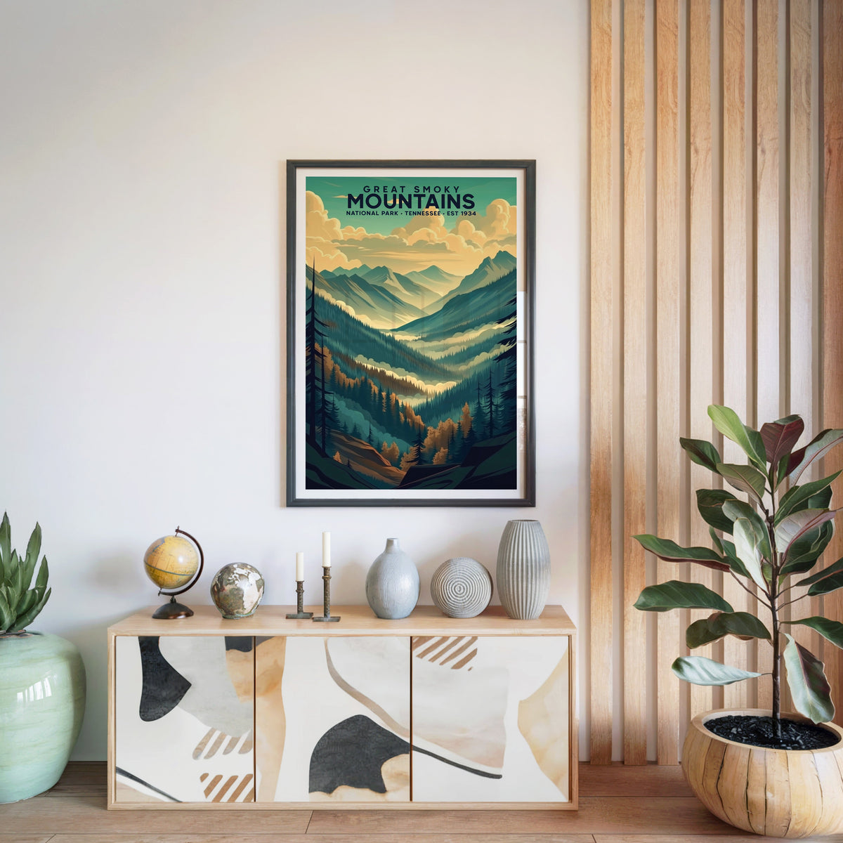 Great Smoky Mountains print in a black frame above a light wood sideboard with a globe and vases