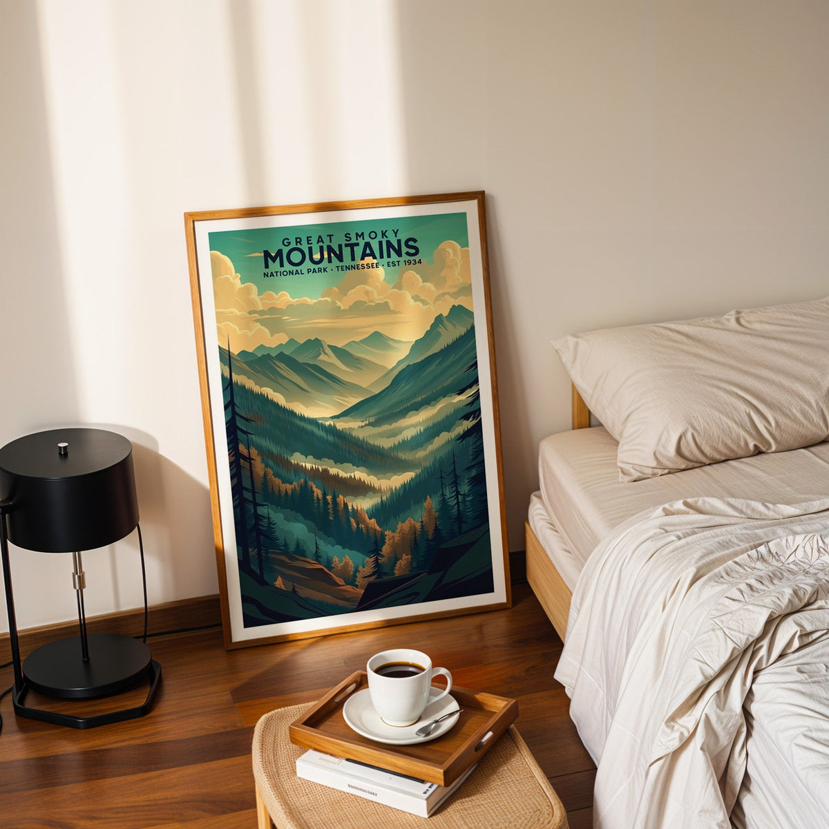 Great Smoky Mountains print in an oak frame leaning on a bedroom floor beside the bed and a tray