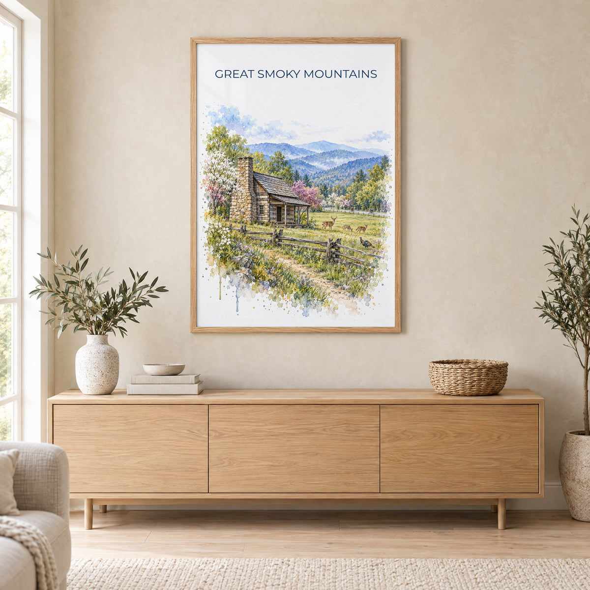 Great Smoky Mountains National Park watercolor in an oak frame above a light wood sideboard in a Scandinavian living room