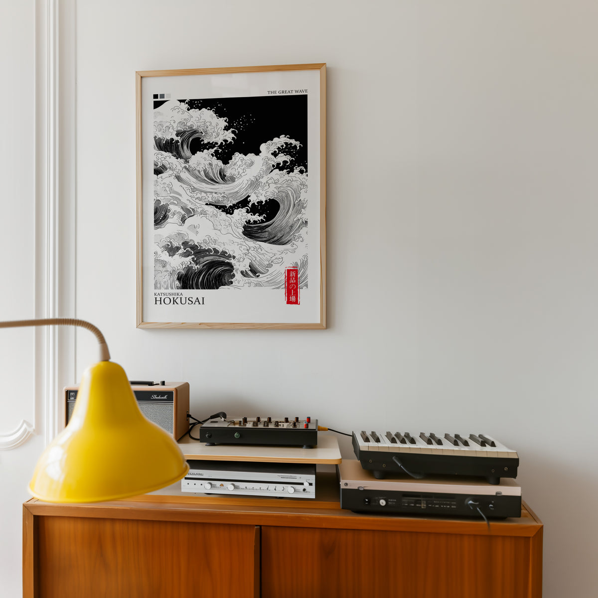 Black and white Great Wave print in an oak frame above a teak sideboard with vintage hi-fi