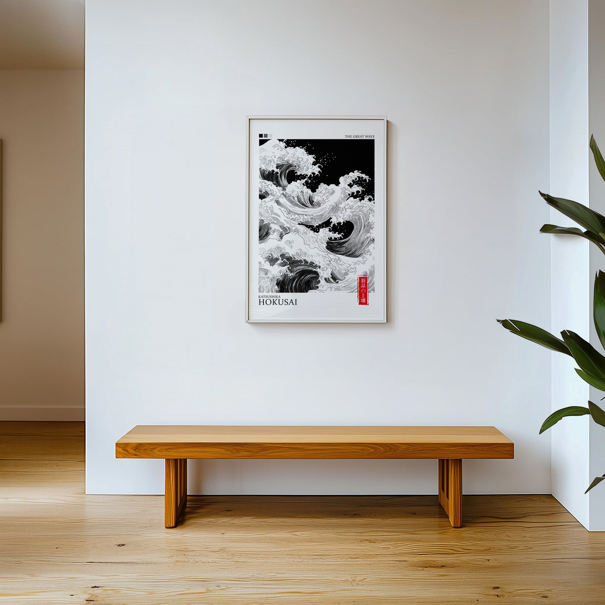 Black and white Great Wave print shown in a white frame above a wooden entryway bench