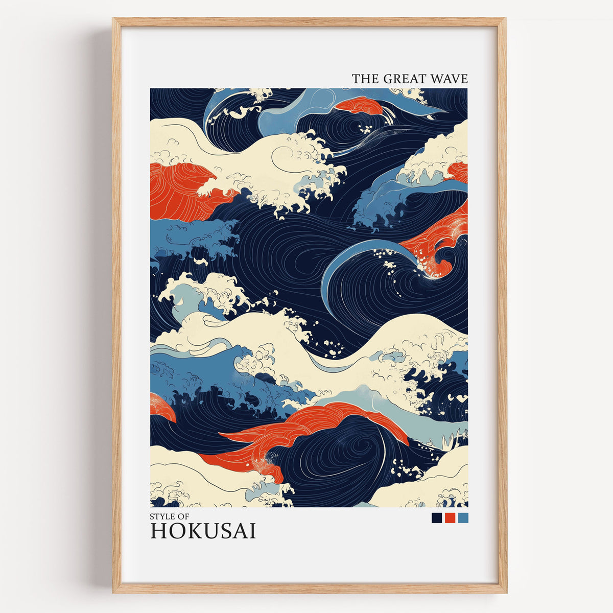 Navy and orange Great Wave print in a light oak frame on a plain white wall