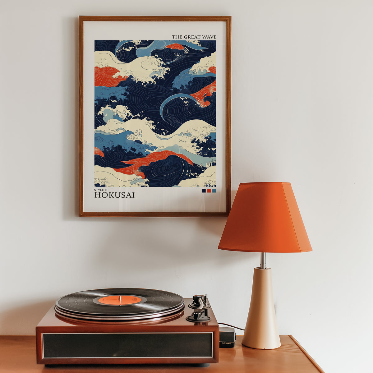 Navy and orange Great Wave print in a walnut frame above a sideboard with a record player