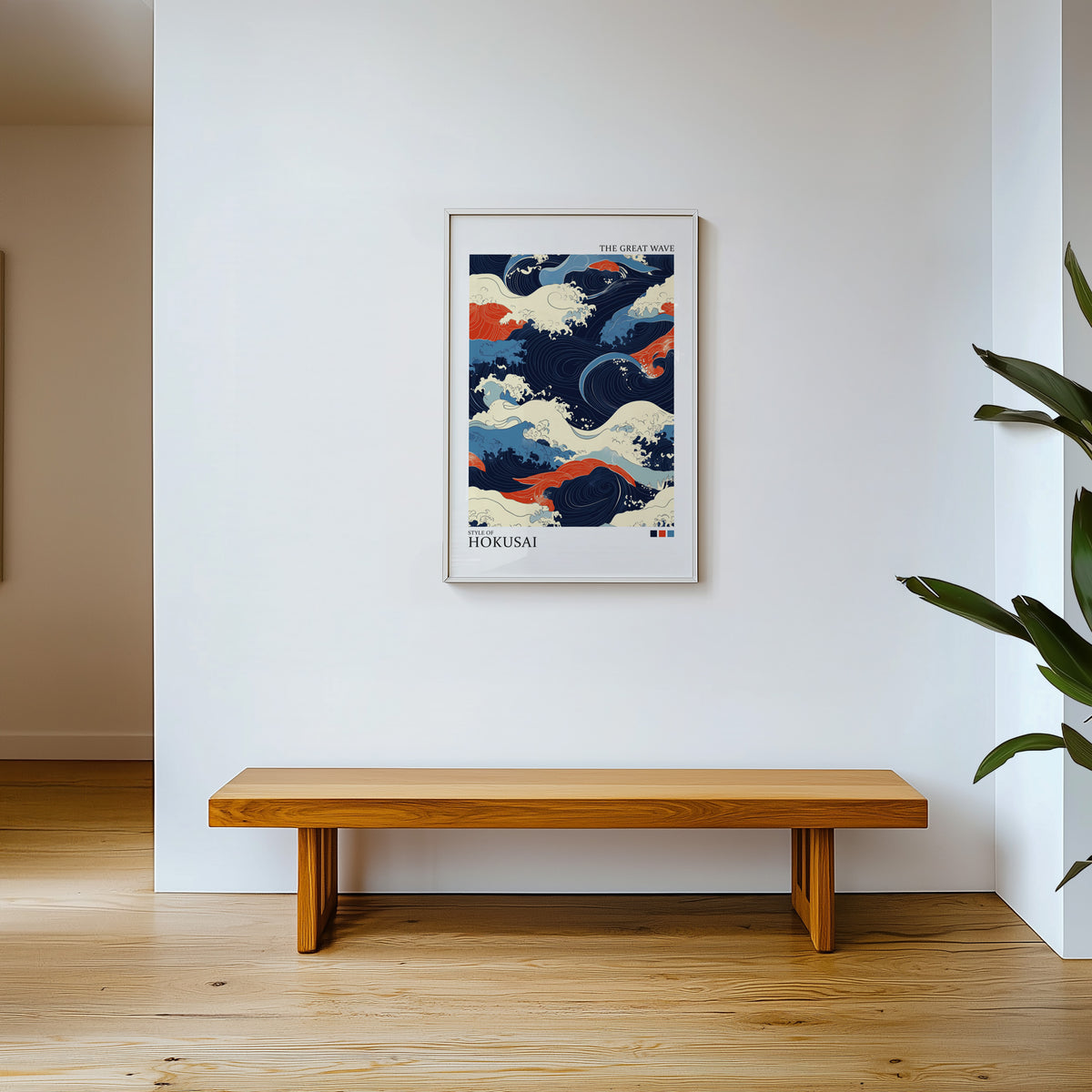 Navy and orange Great Wave print shown in a white frame above a wooden entryway bench