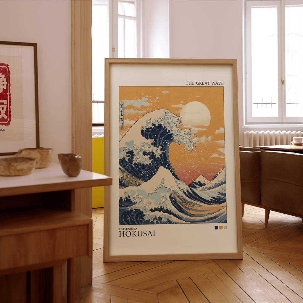 Great Wave under orange sky print in an oak frame on the parquet floor of a sunlit living room