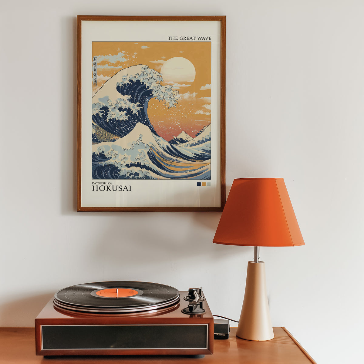 Great Wave under orange sky print in a walnut frame above a sideboard with a record player