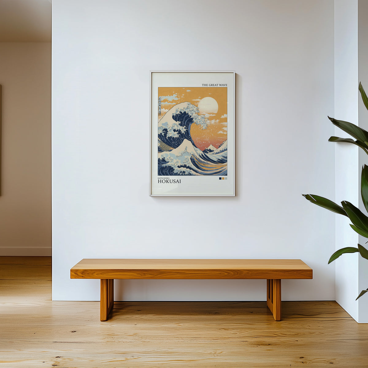 Great Wave under orange sky print shown in a white frame above a wooden entryway bench