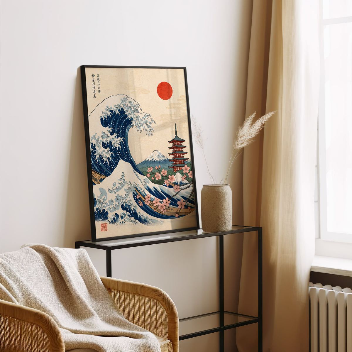 Great Wave with pagoda and cherry blossom print in a black frame leaning on a glass console beside pampas grass