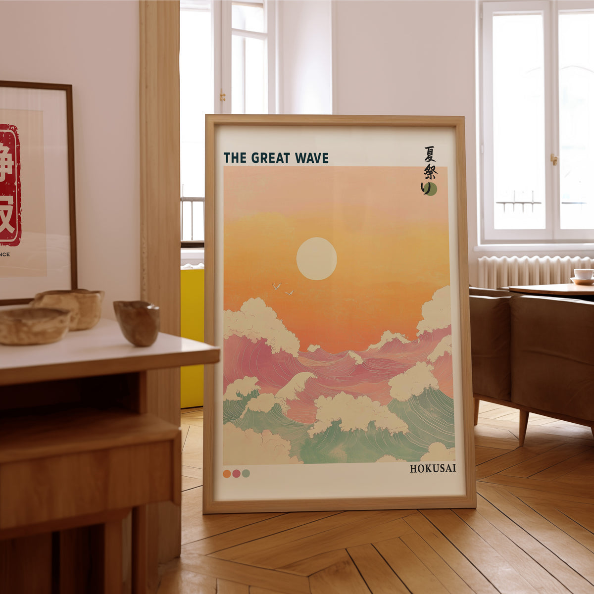Pastel Great Wave sunset print in an oak frame on the parquet floor of a sunlit living room