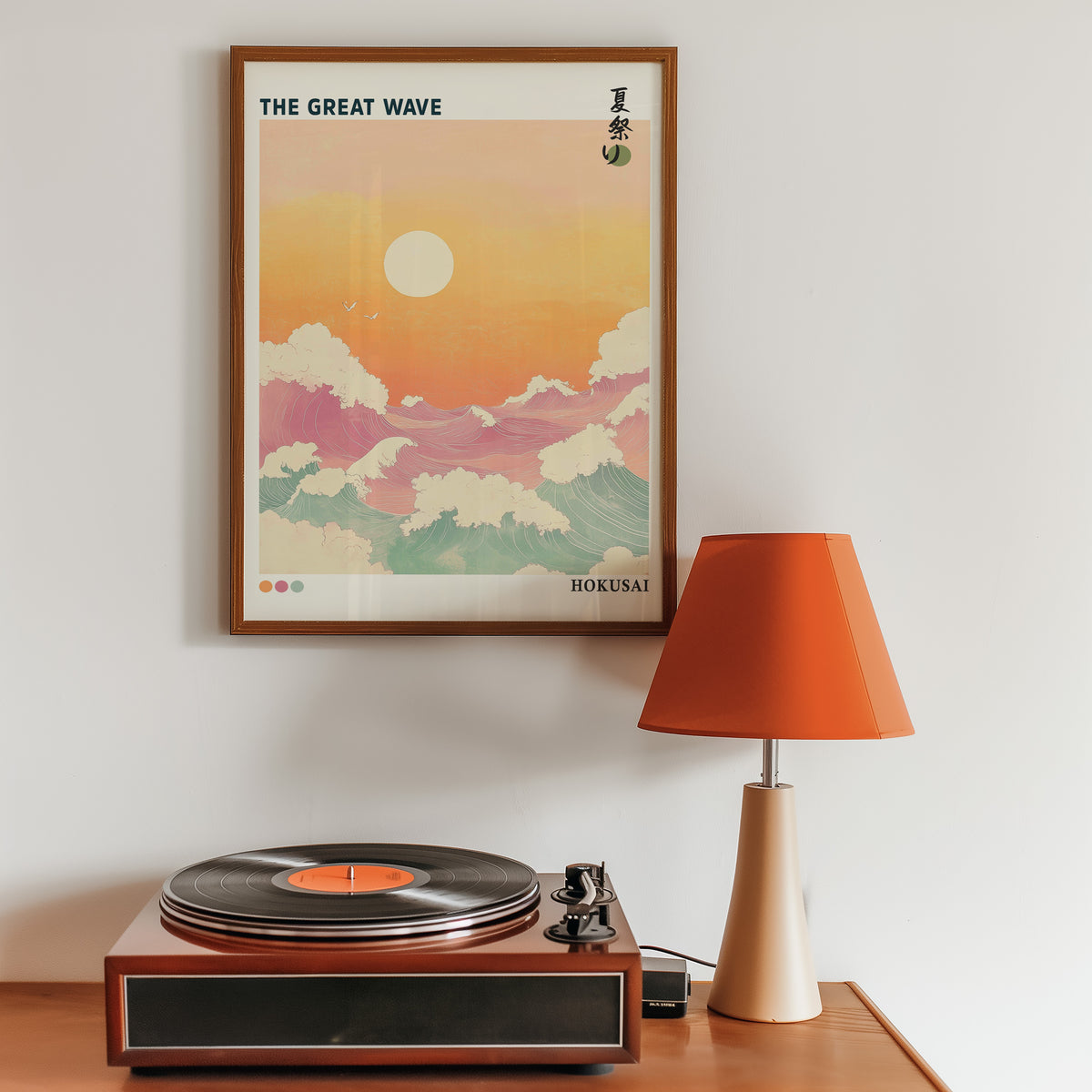 Pastel Great Wave sunset print in a walnut frame above a sideboard with a record player