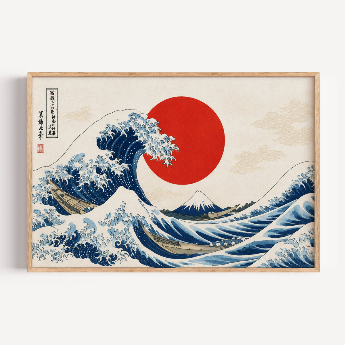 Great Wave with a red sun print in a light oak frame on a plain white wall