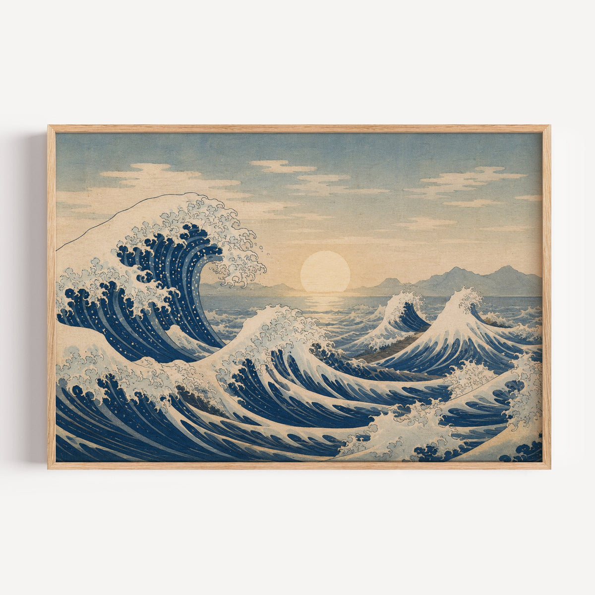 Great wave at sunrise over the sea print in a light oak frame on a plain white wall