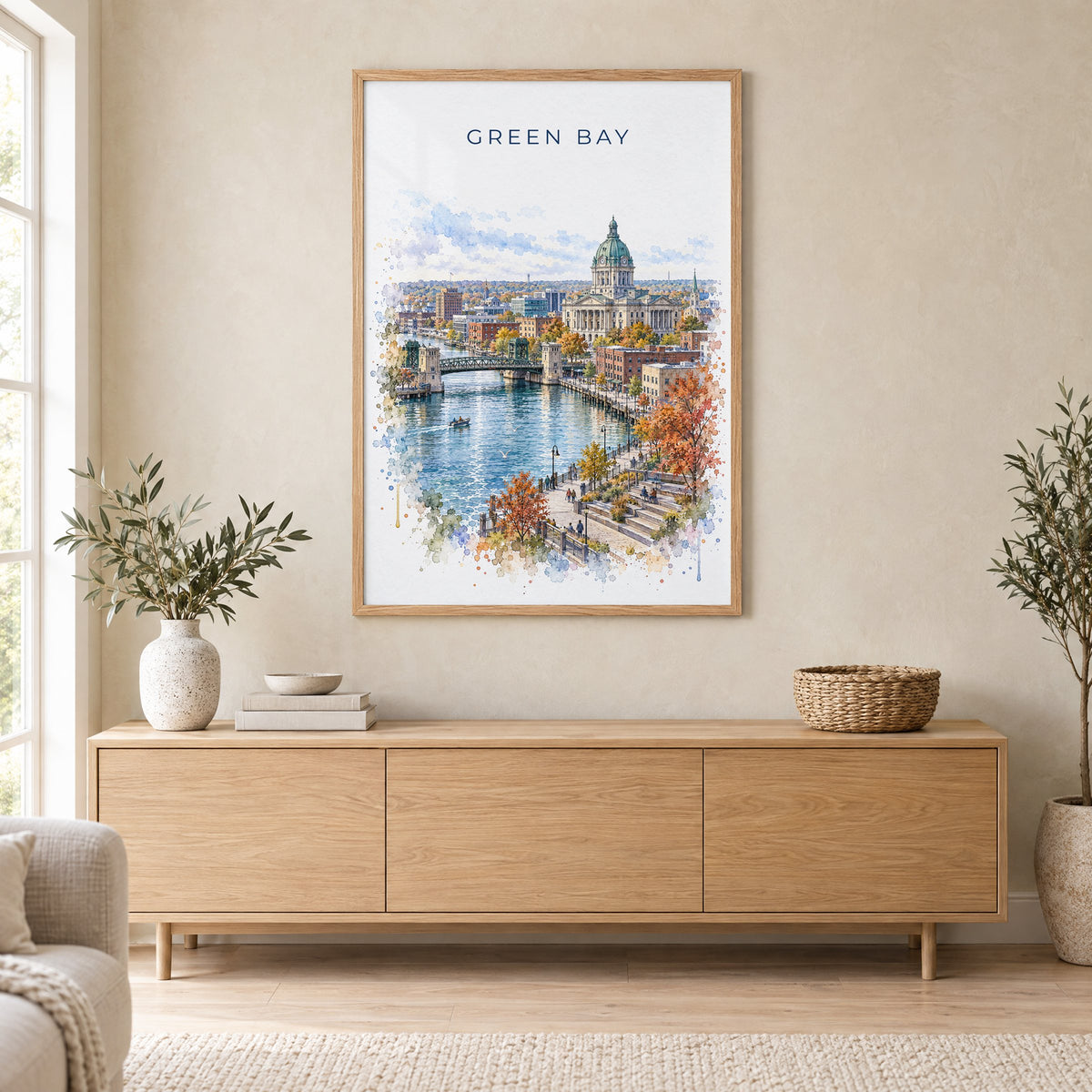 Green Bay watercolor print in an oak frame above a light wood sideboard in a Scandinavian living room
