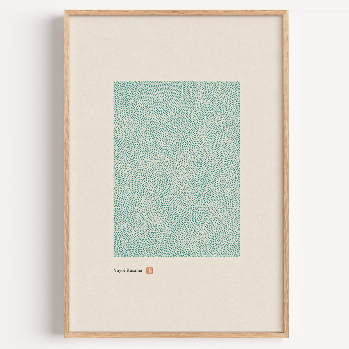 green dot field abstract print in a light oak frame on a plain white wall