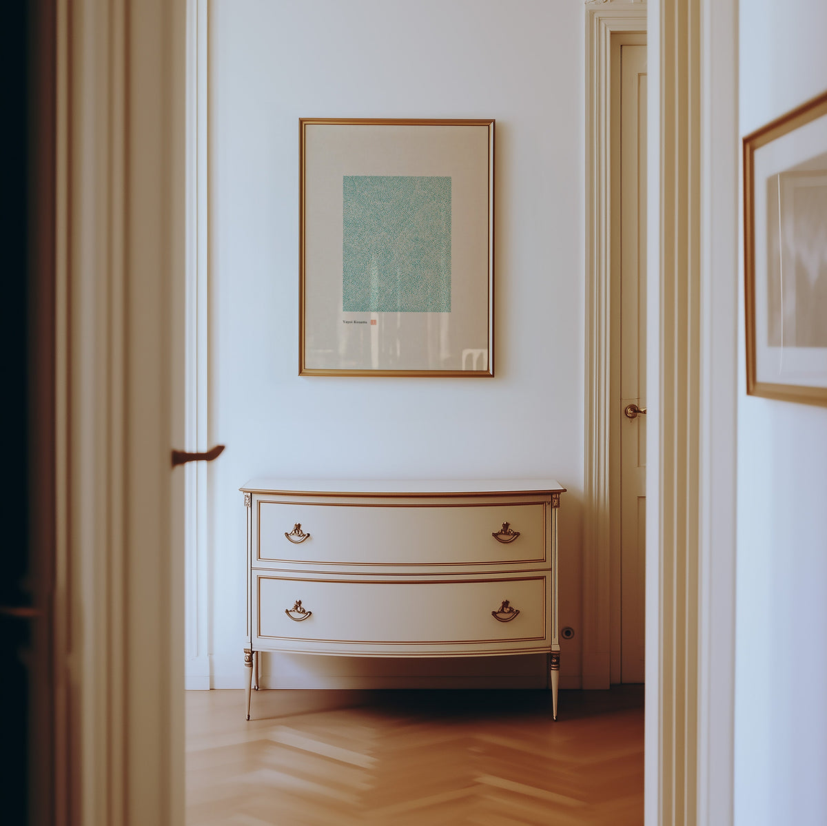 green dot field abstract print shown in a gold frame in a hallway above a cream dresser