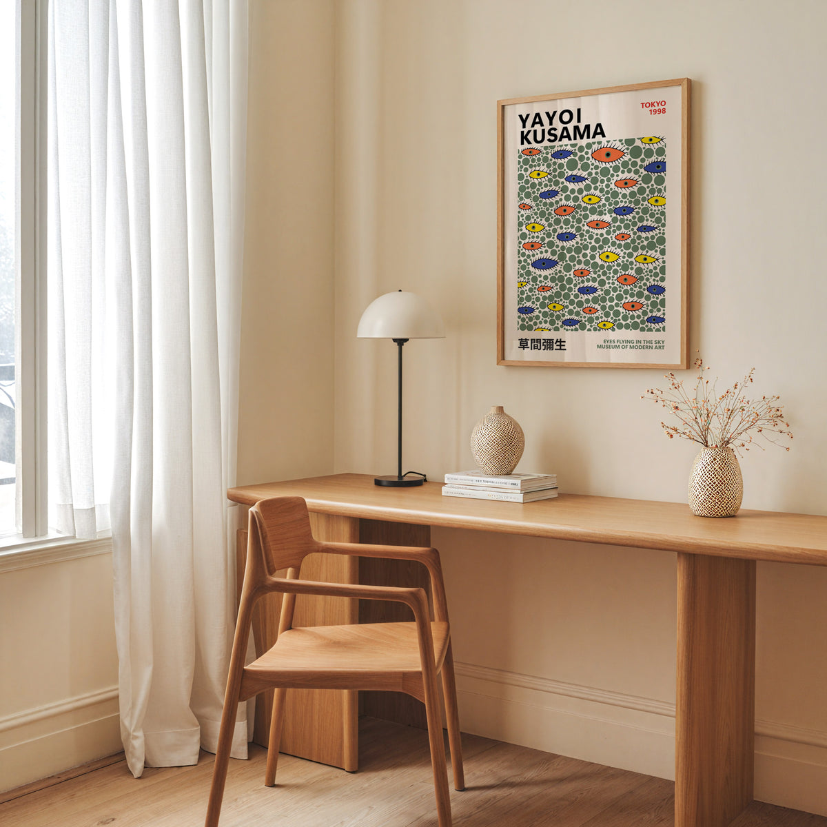 Yayoi Kusama inspired green dots and eyes print above a desk with a dome lamp