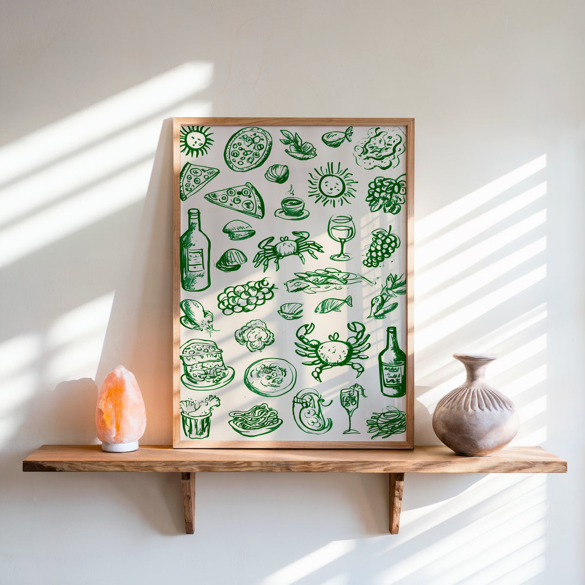 Green food doodle print in an oak frame on a live-edge shelf beside a salt lamp