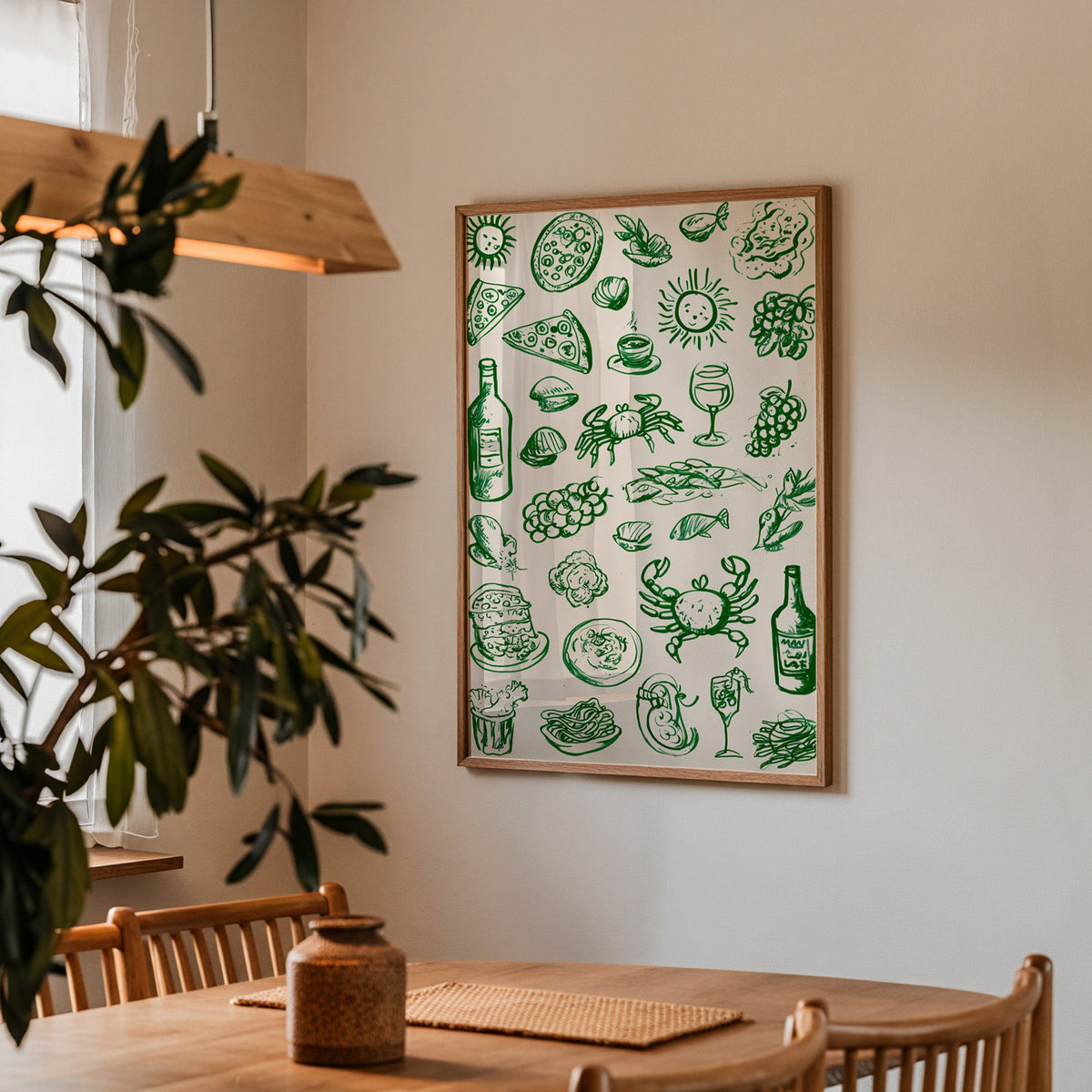 Green food doodle print in a walnut frame above a dining table with olive branches