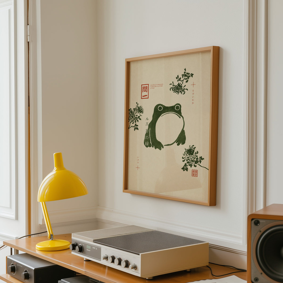 green frog with chrysanthemums print in an oak frame above a vintage hi-fi shelf with a yellow desk lamp