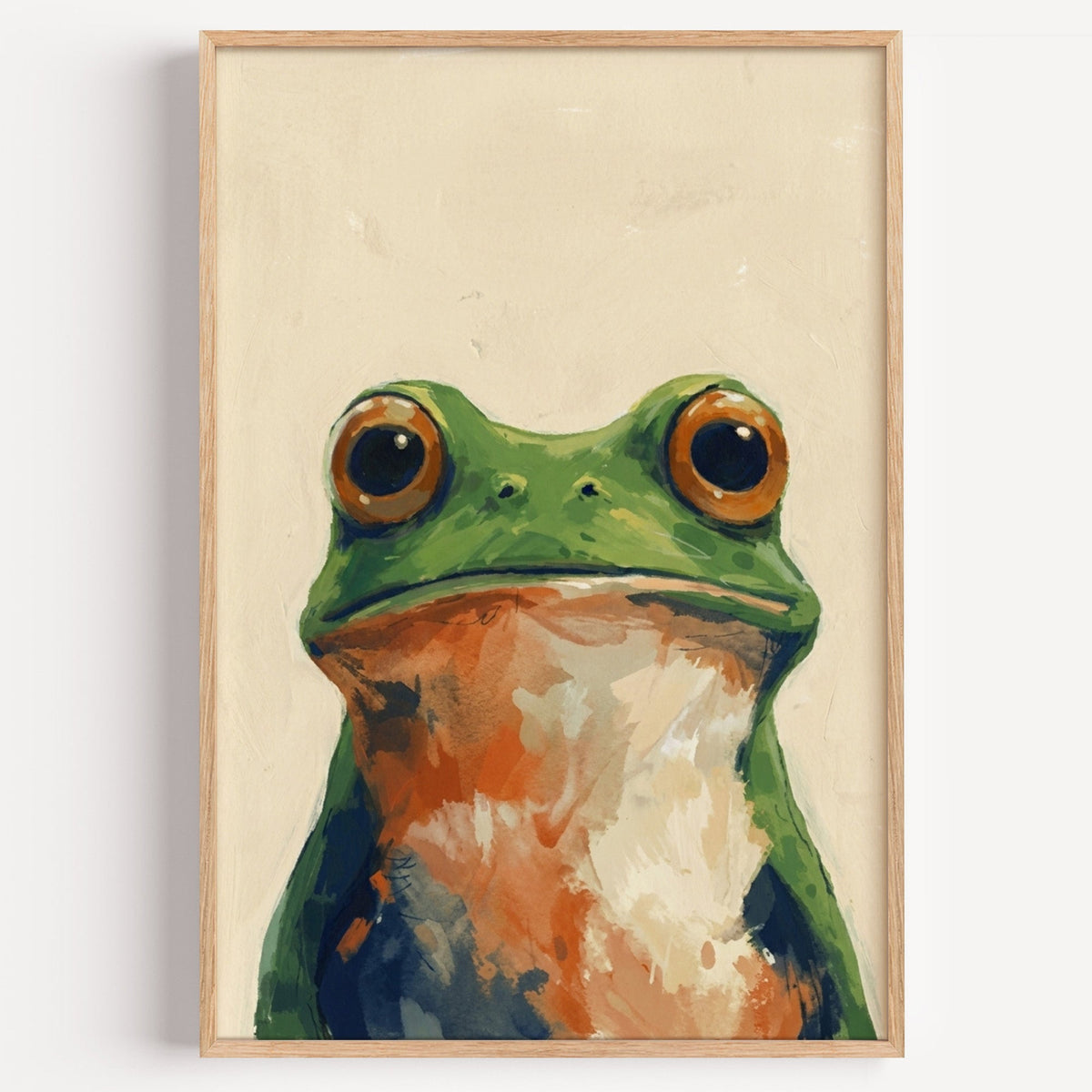 Green frog portrait print in a light oak frame on a plain white wall