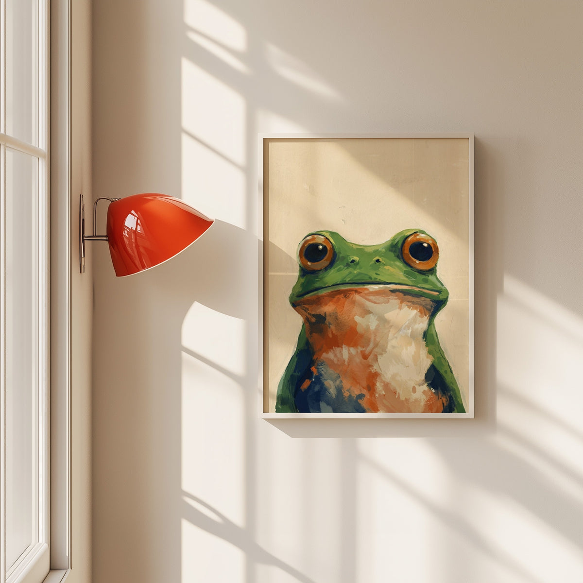 Green frog portrait print in a white frame beside a red wall sconce