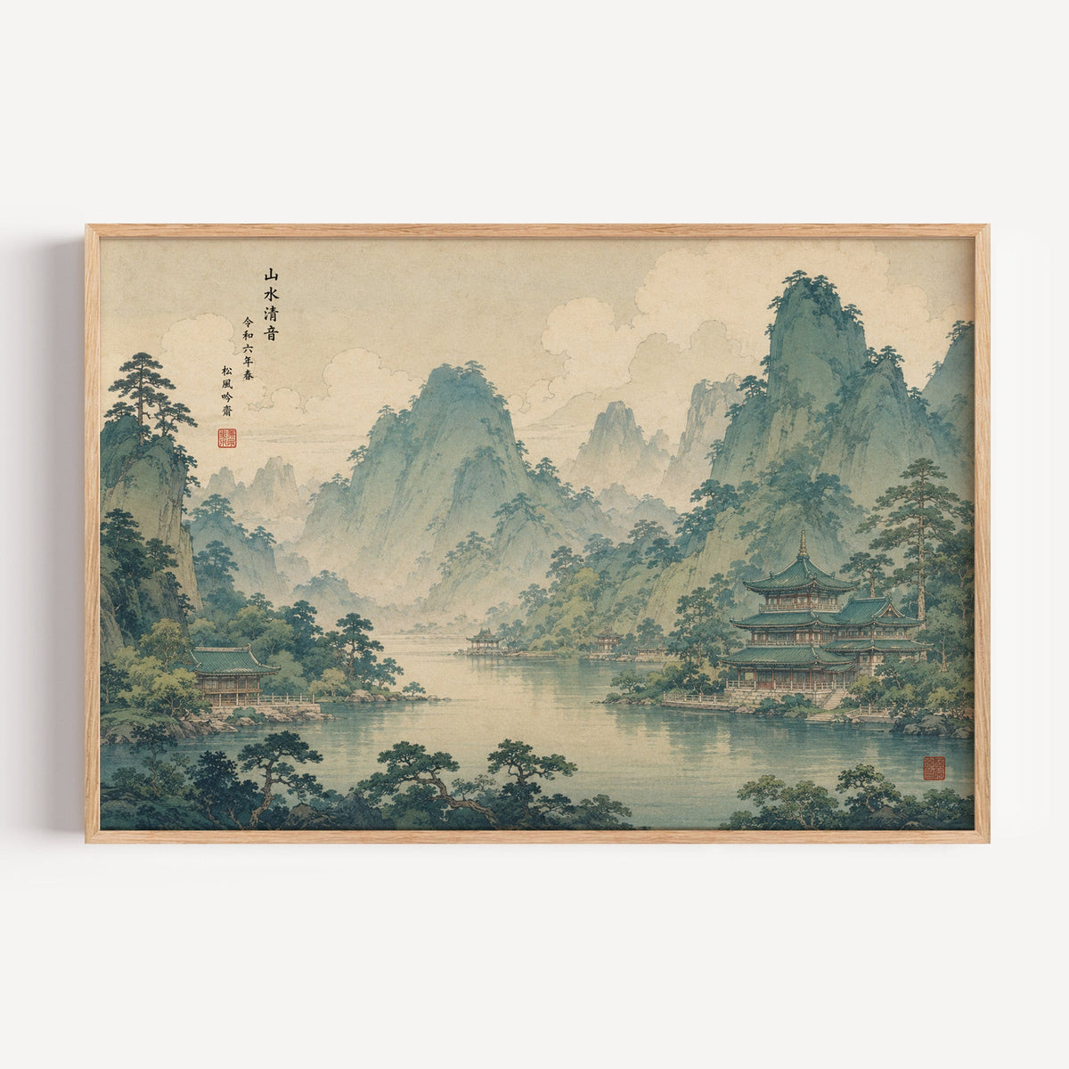 Green mountain lake with temples print in a light oak frame on a plain white wall