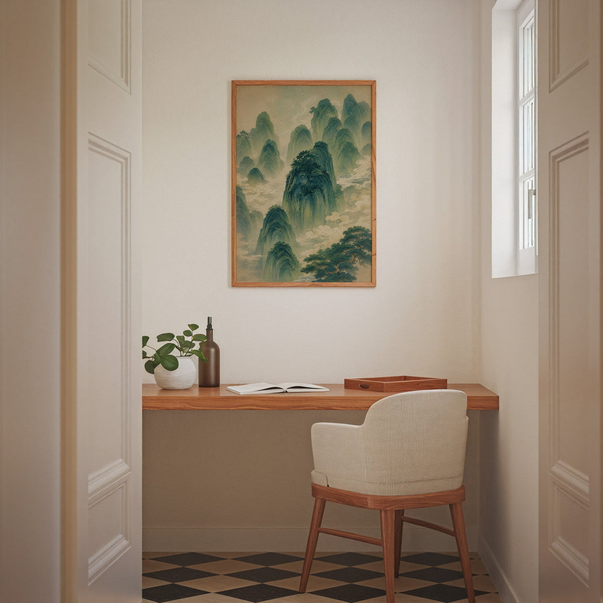 green mountains and clouds landscape print in an oak frame above a wall-mounted desk in a home office nook
