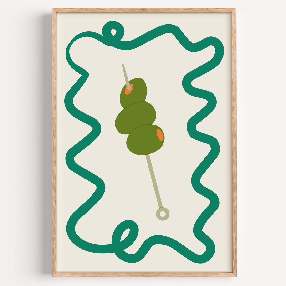 Green olives cocktail pick print in a light oak frame on a plain white wall