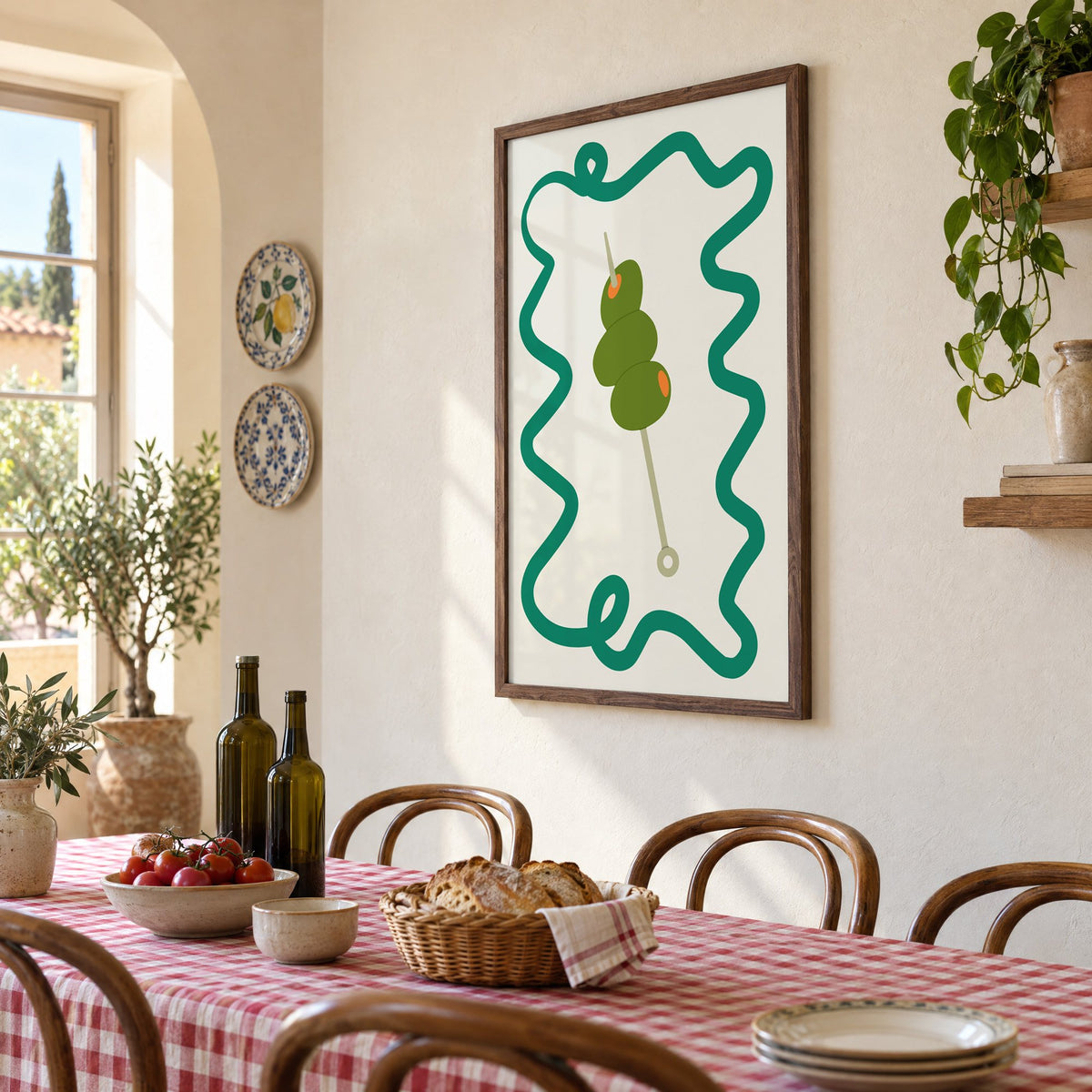 Green olives cocktail pick print in a walnut frame above a gingham-covered trattoria table, seen at an angle