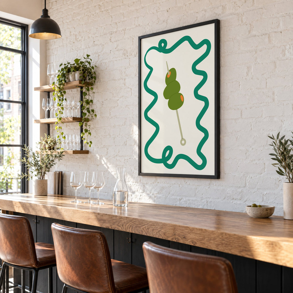 Green olives cocktail pick print in a black frame on a white brick wall above a wine bar counter