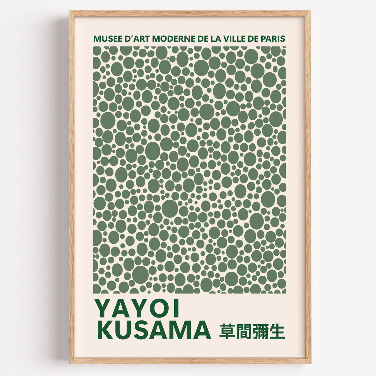 Yayoi Kusama inspired green polka dot pattern print in a wood frame on a plain wall