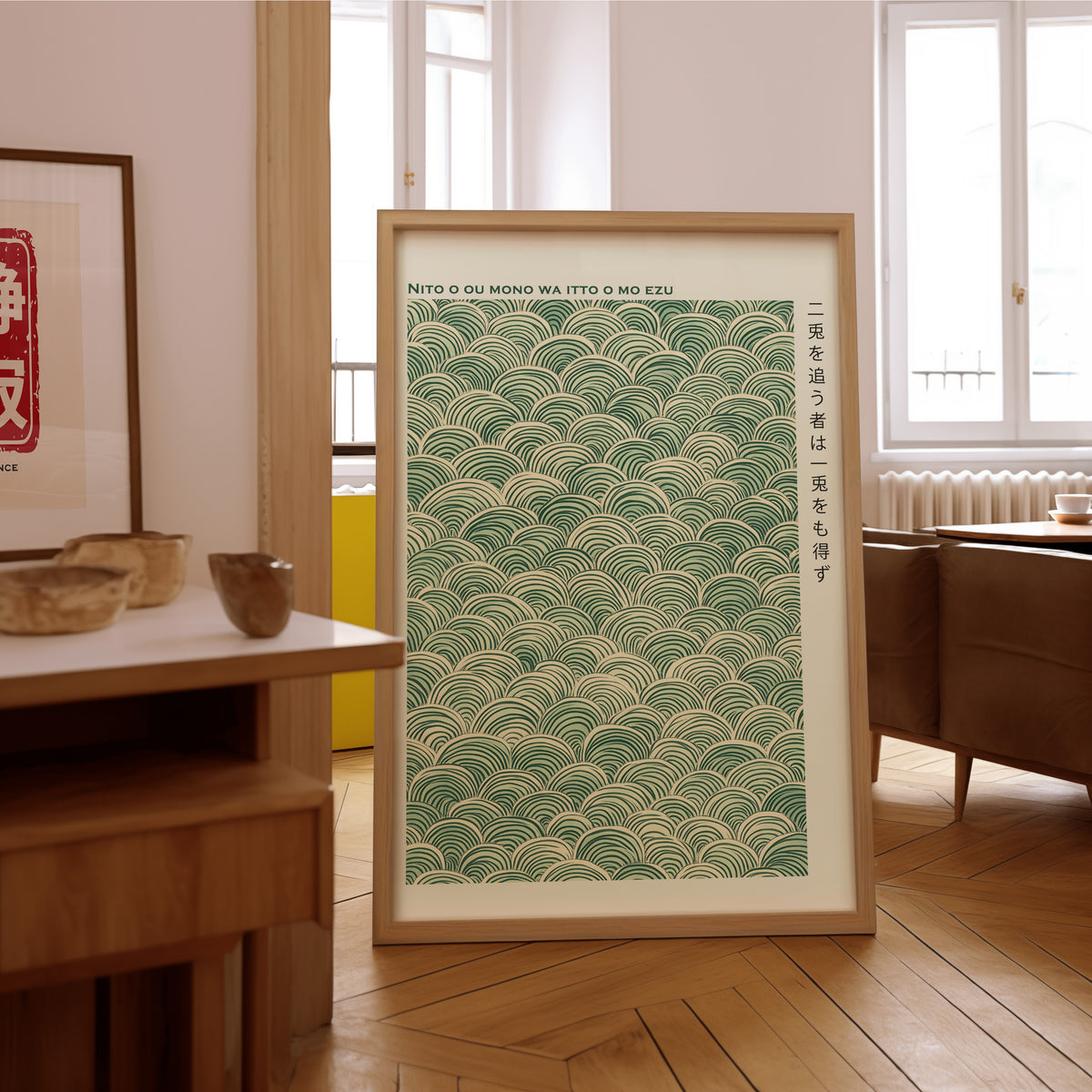 Green seigaiha wave proverb print in an oak frame on the parquet floor of a sunlit living room