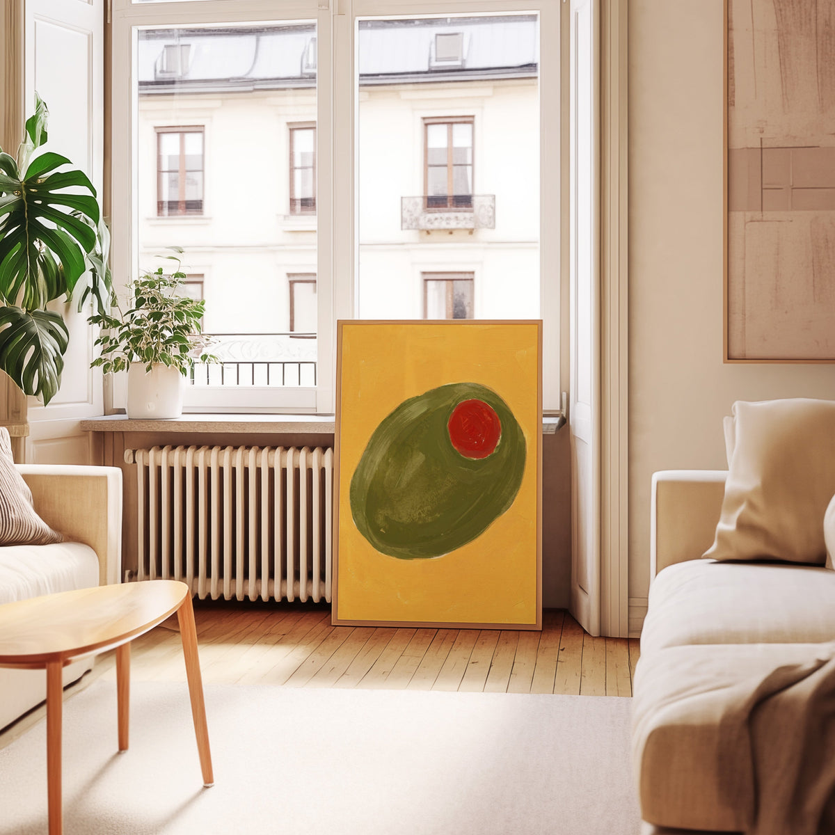 Cocktail olive print in an oak frame leaning below tall French windows