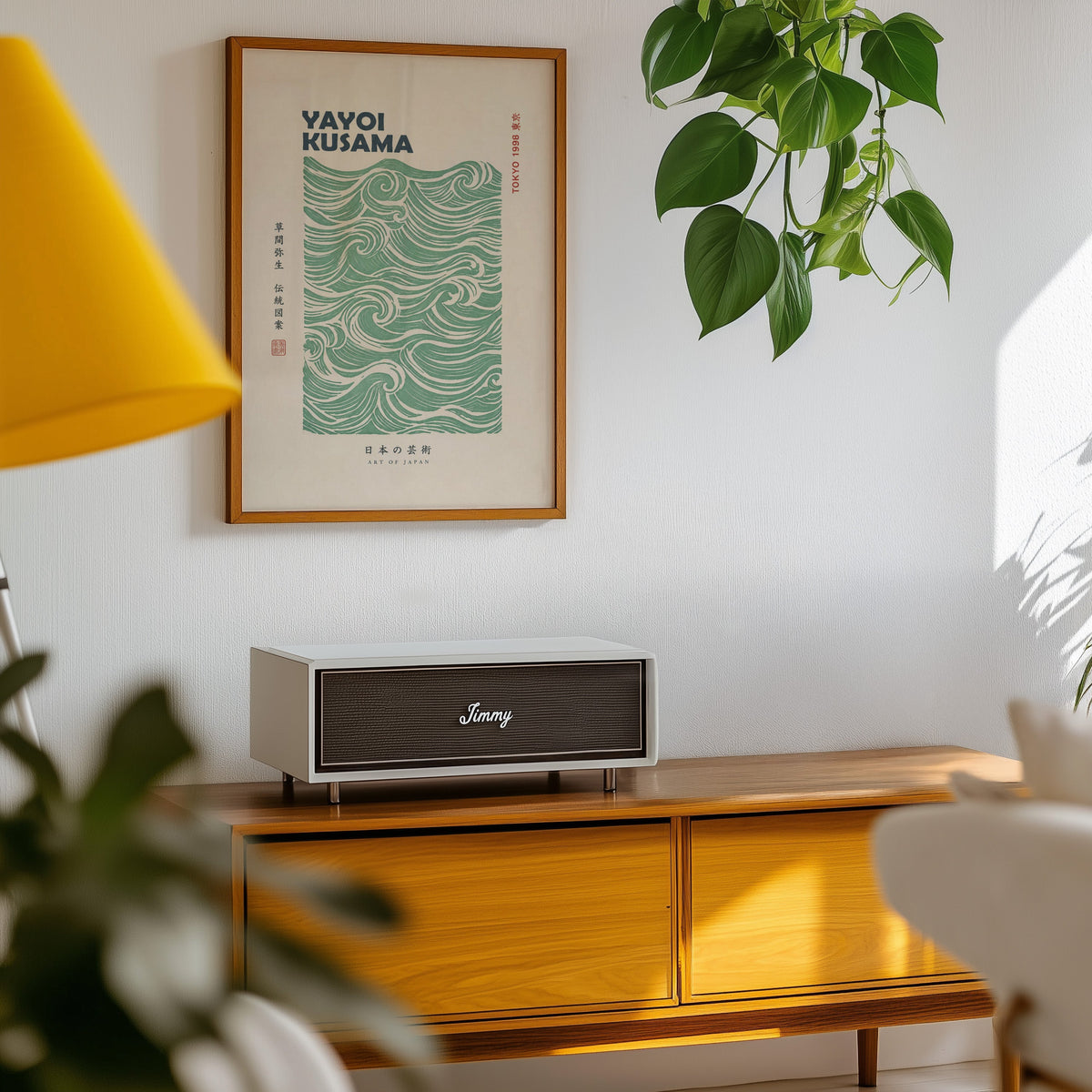 green wave pattern with bold type print in an oak frame above a teak mid-century sideboard with trailing pothos