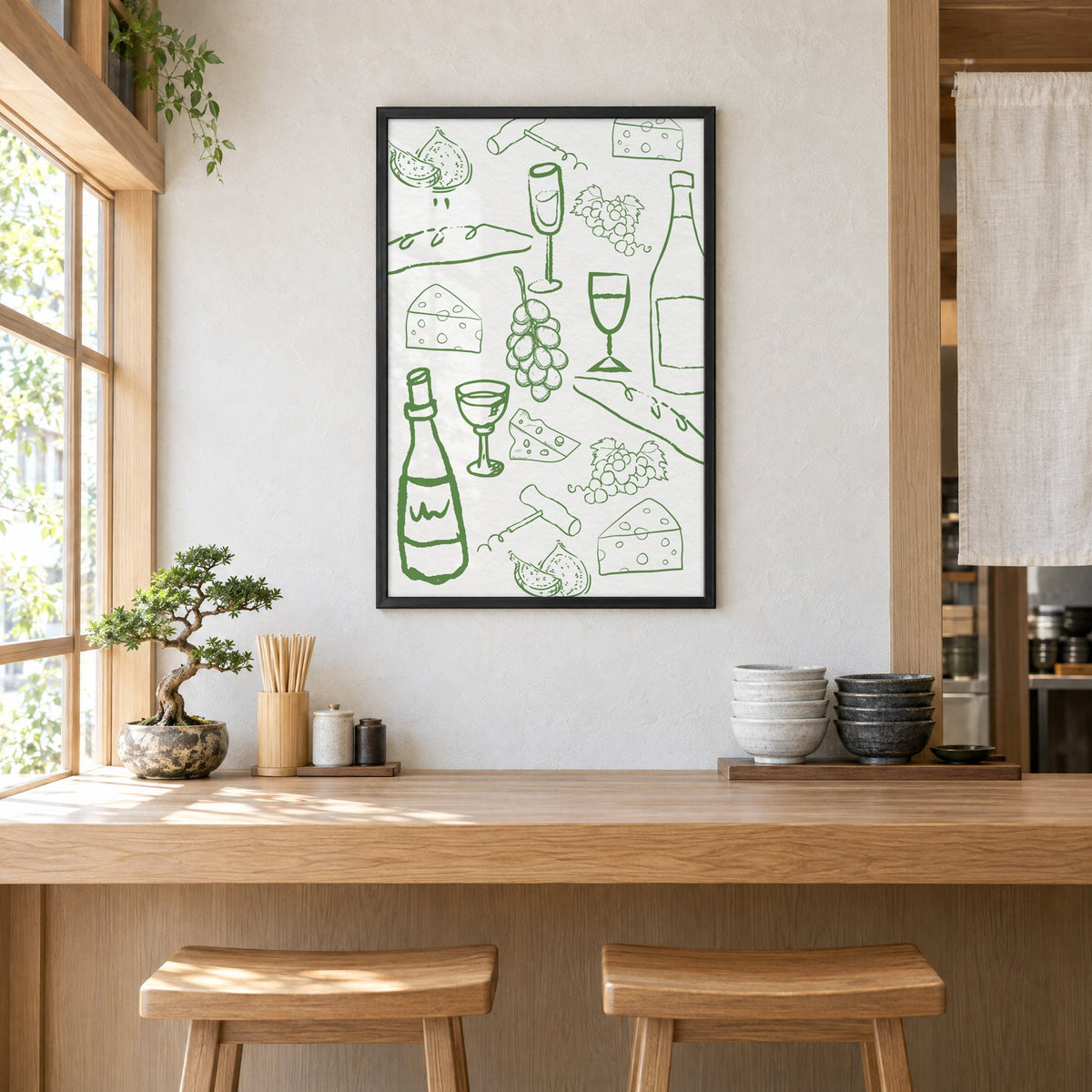 Green wine and cheese doodle pattern print in a black frame above a light wood ramen counter with stools and stacked bowls