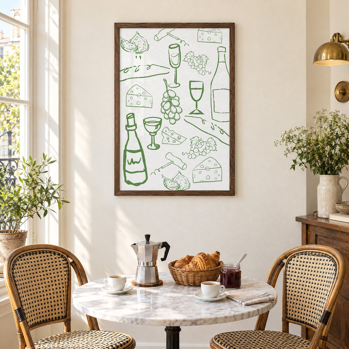 Green wine and cheese doodle pattern print in a walnut frame above a marble bistro table with croissants and rattan chairs