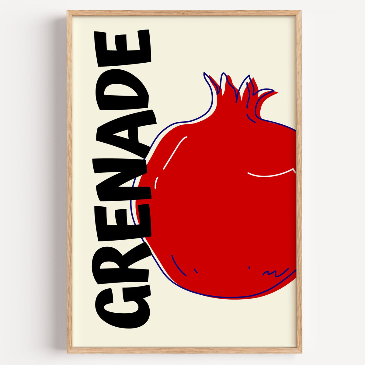 GRENADE red pomegranate print in a light oak frame on a plain white wall