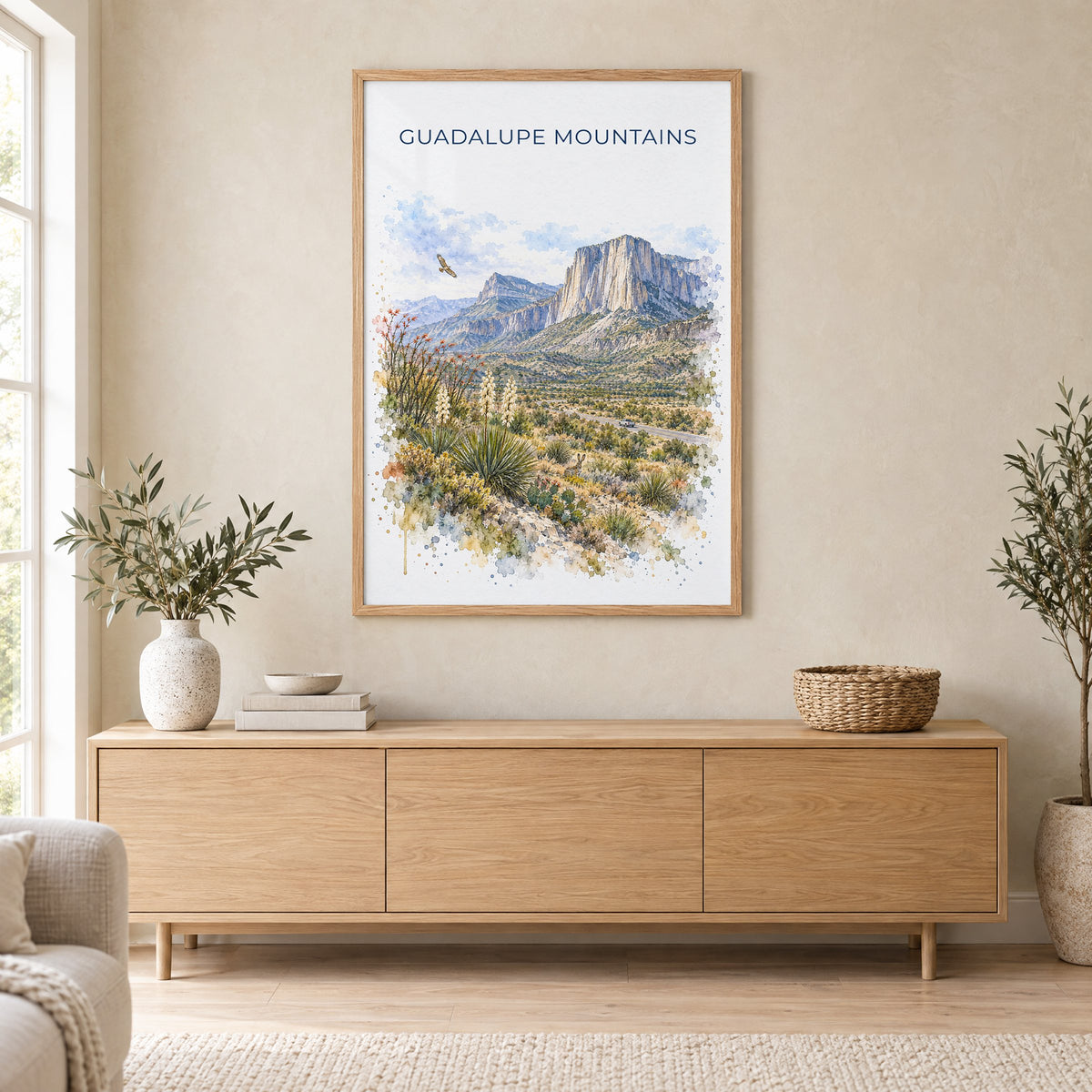 Guadalupe Mountains National Park watercolor print in an oak frame above a light wood sideboard in a Scandinavian living room