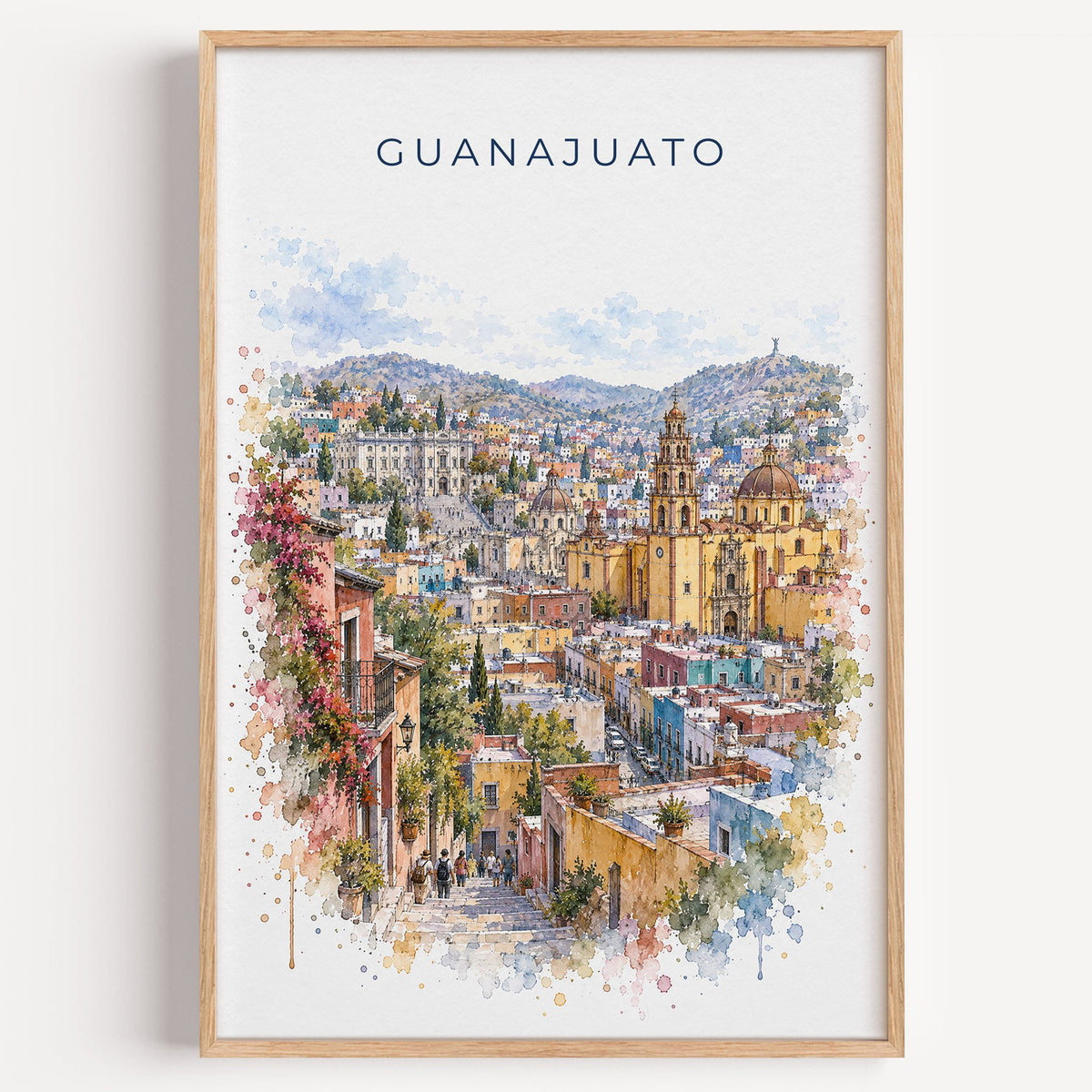 Guanajuato watercolor print in a light oak frame on a plain white wall
