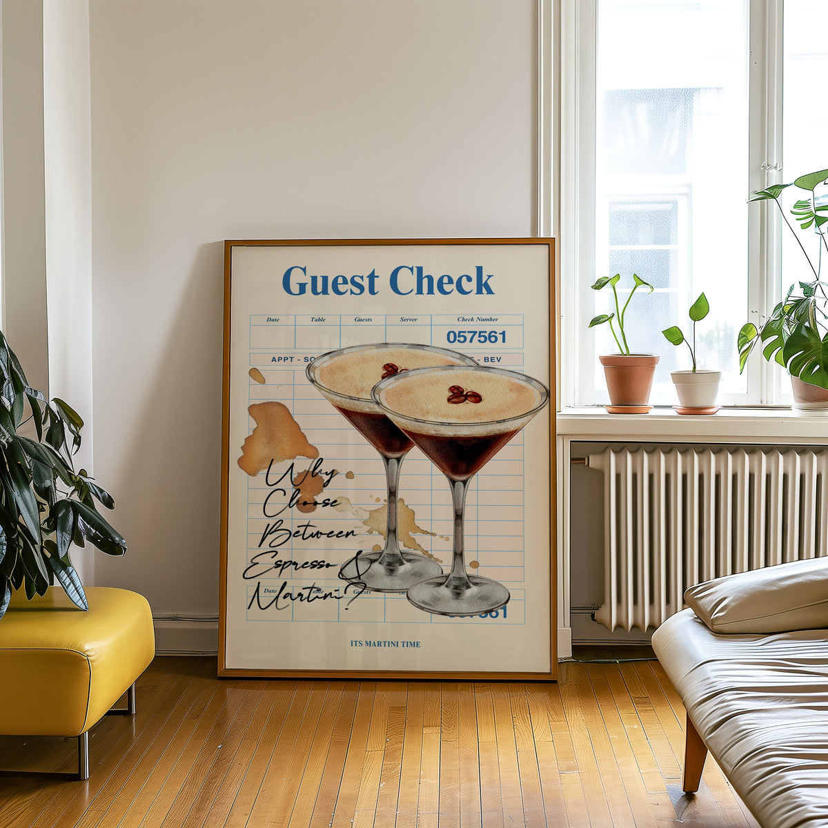 Guest check espresso martini print in an oak frame leaning on a wooden floor beside a yellow leather bench
