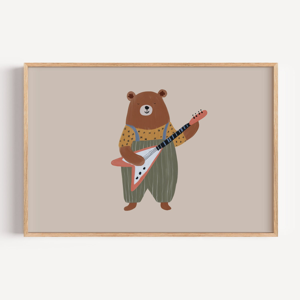 Landscape guitar bear green overalls nursery print in a light oak frame on a plain white wall