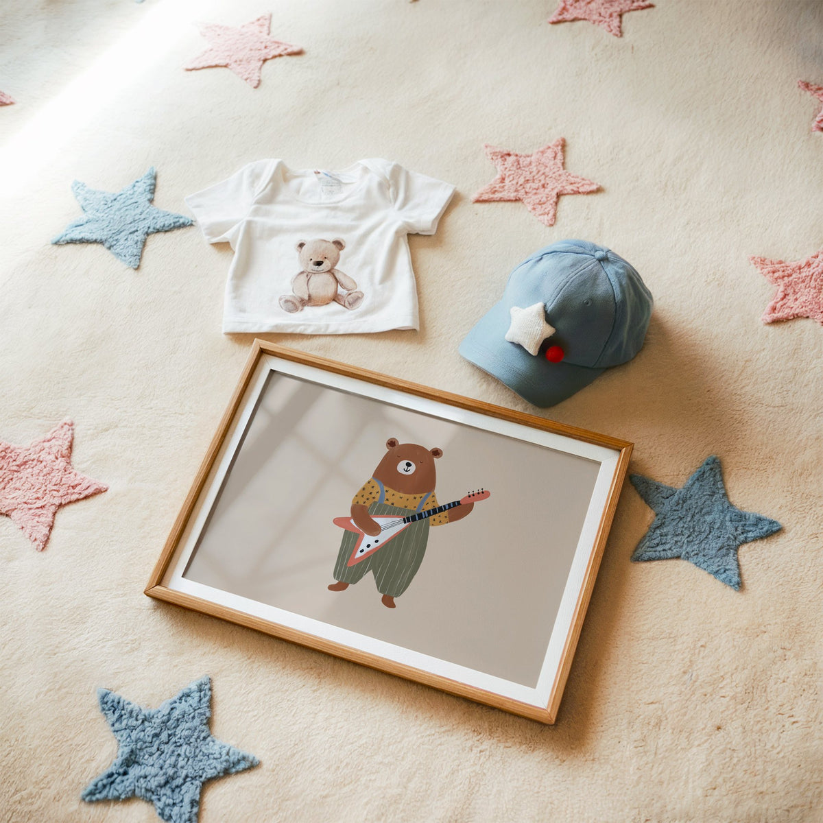 Landscape guitar bear green overalls nursery print in a matted oak frame on a star rug with a baby tee