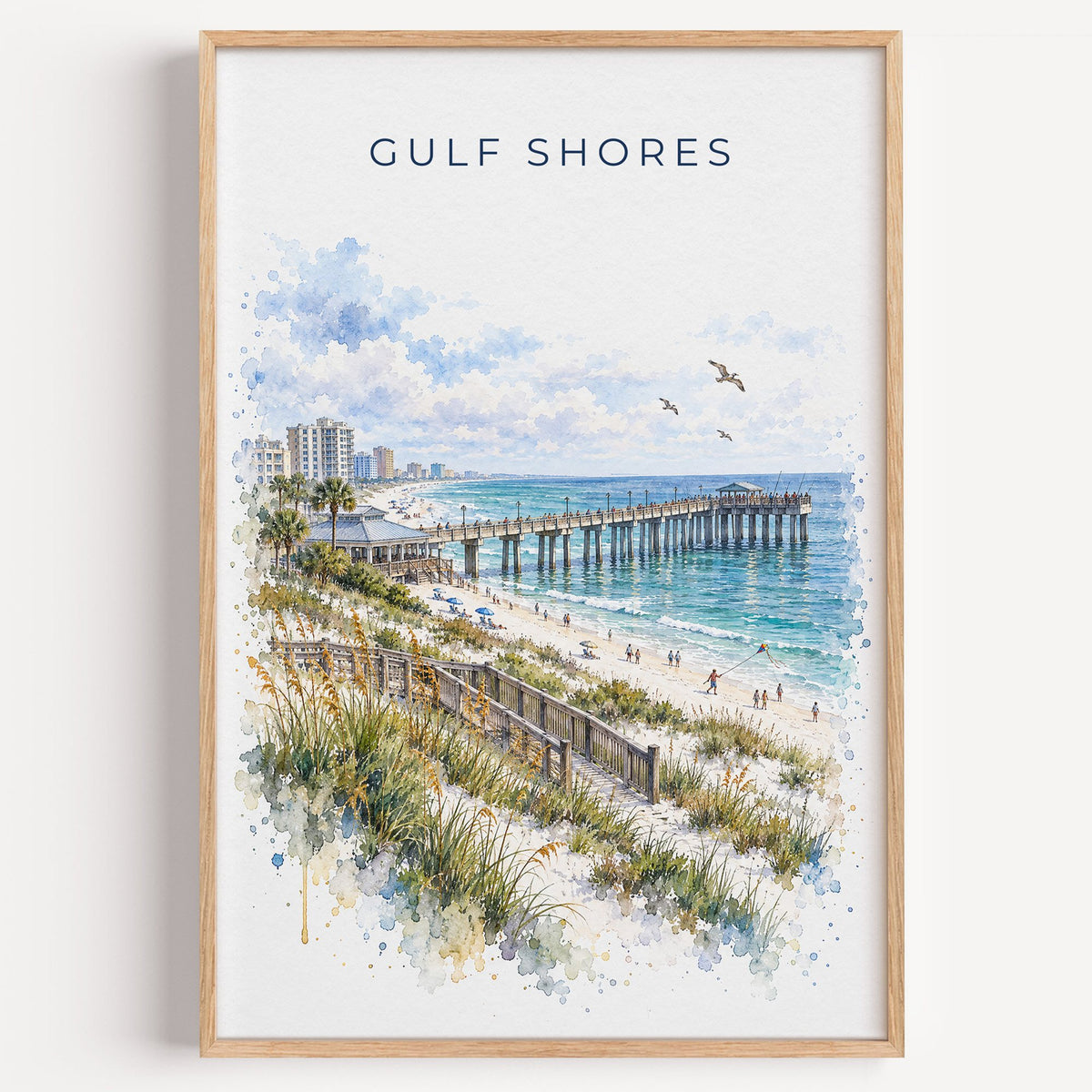 Gulf Shores watercolor print in a light oak frame on a plain white wall