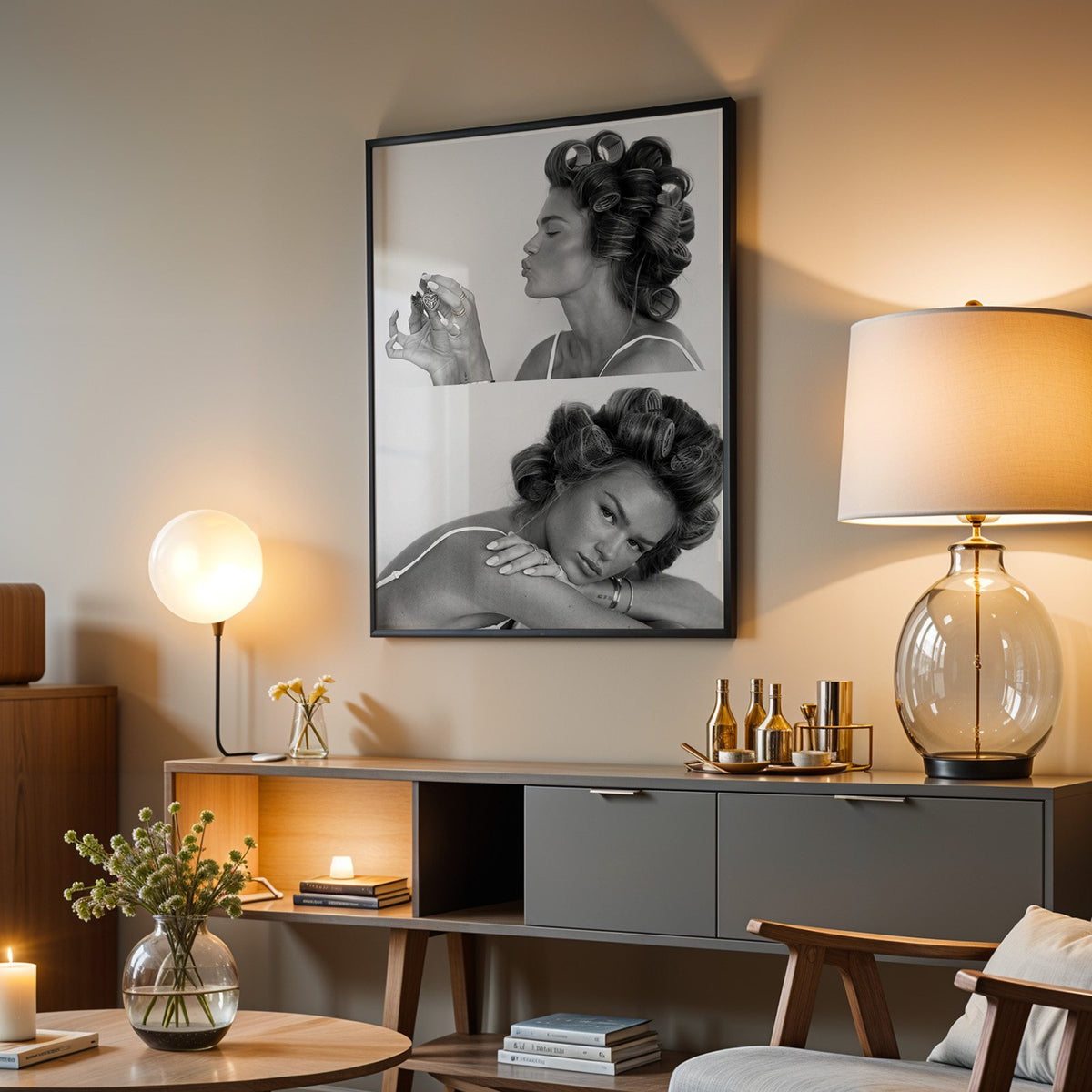 Woman in hair rollers with heart locket two frames print in a black frame above a grey media console with a glass table lamp