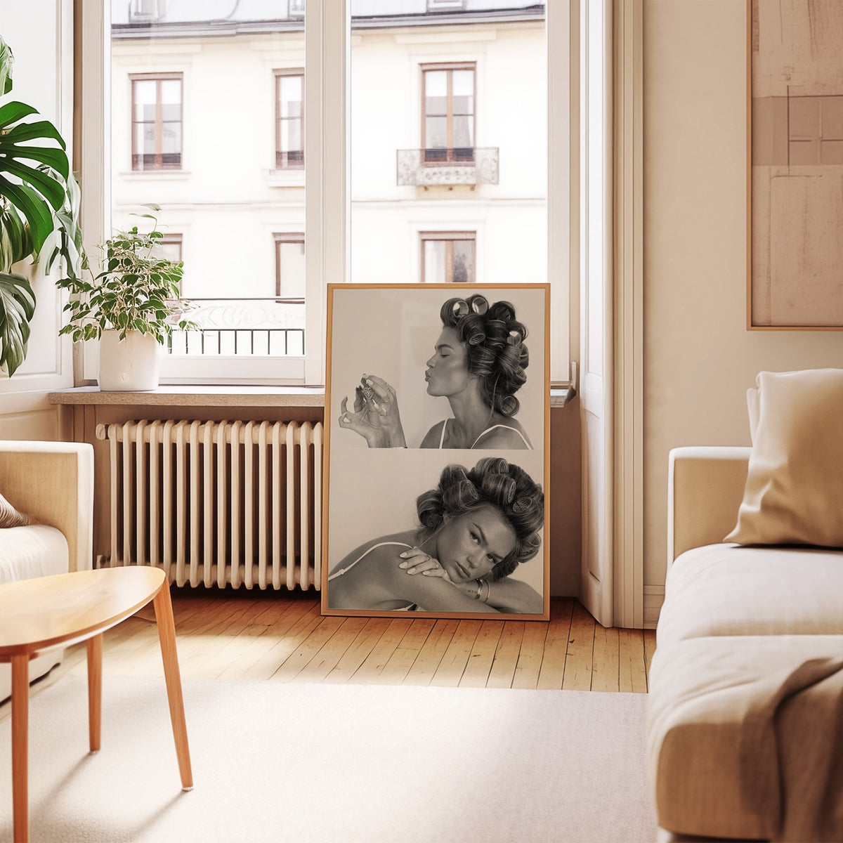 Woman in hair rollers with heart locket two frames print in an oak frame leaning by a French window in a living room