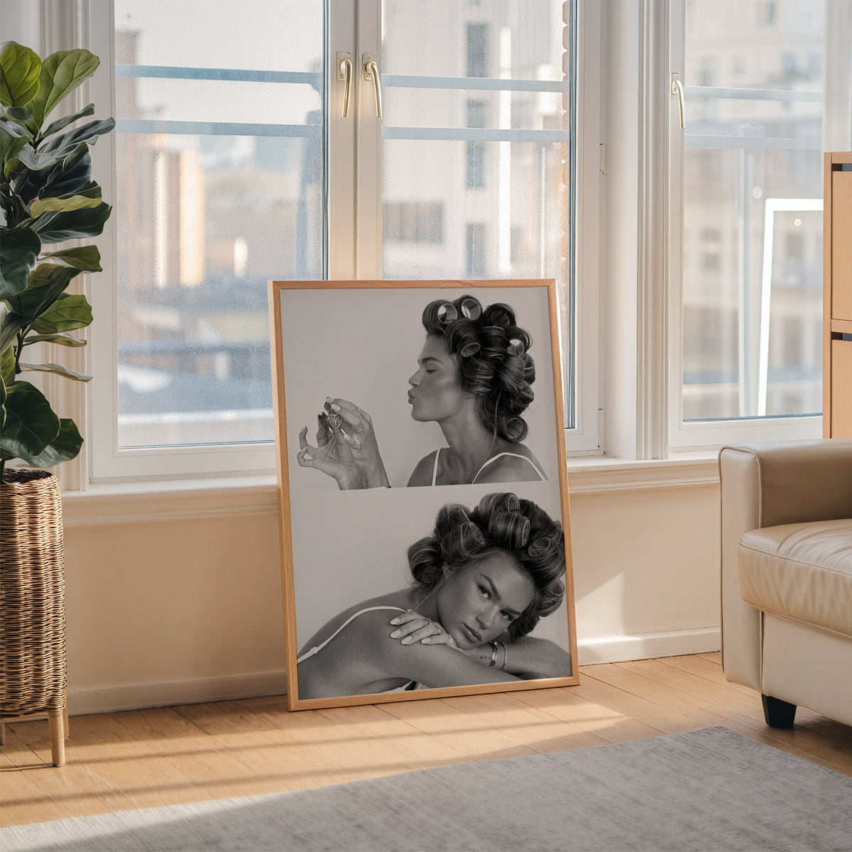 Woman in hair rollers with heart locket two frames print in an oak frame leaning on the floor beside a fiddle leaf fig