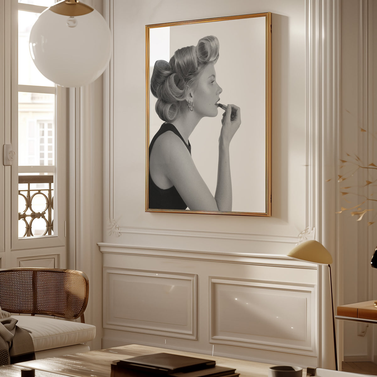 Woman in hair rollers applying lipstick profile print shown in a gold frame in a Parisian paneled living room